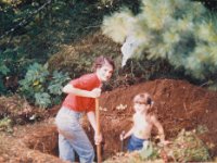 Mary Alice and Yolanda digging the pit for the NEW Outhouse. About 1980